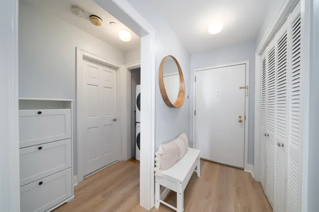 a view of room with wooden floor and mirror