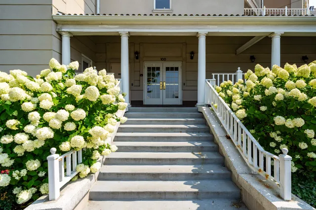 a front view of a house with a garden