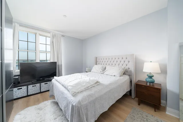 a bedroom with a bed and a flat screen tv