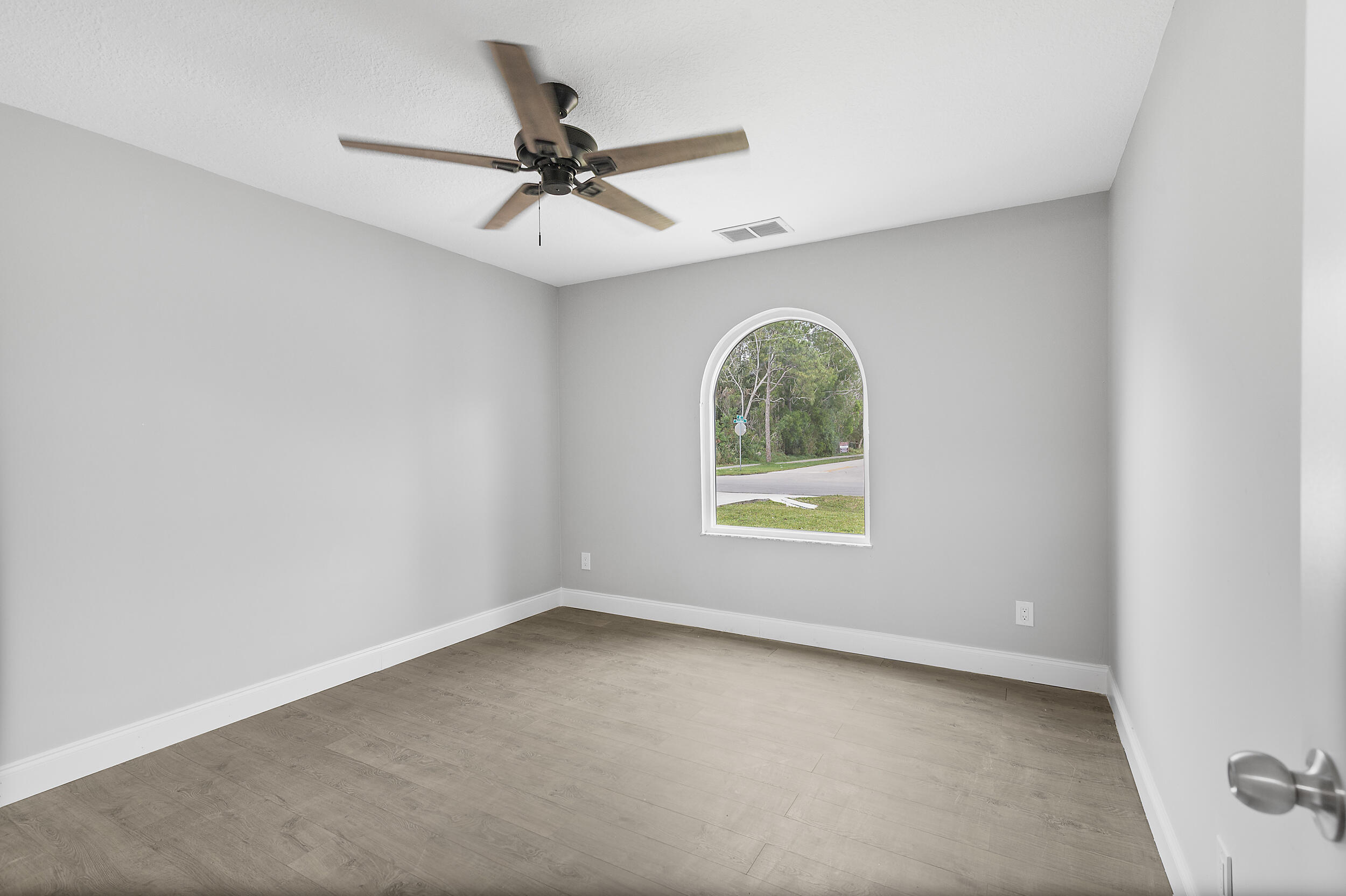 4777 Southeast Salvatori Road Stuart, FL 34997 - Photo 11 of 28 an empty room with a window and a fan