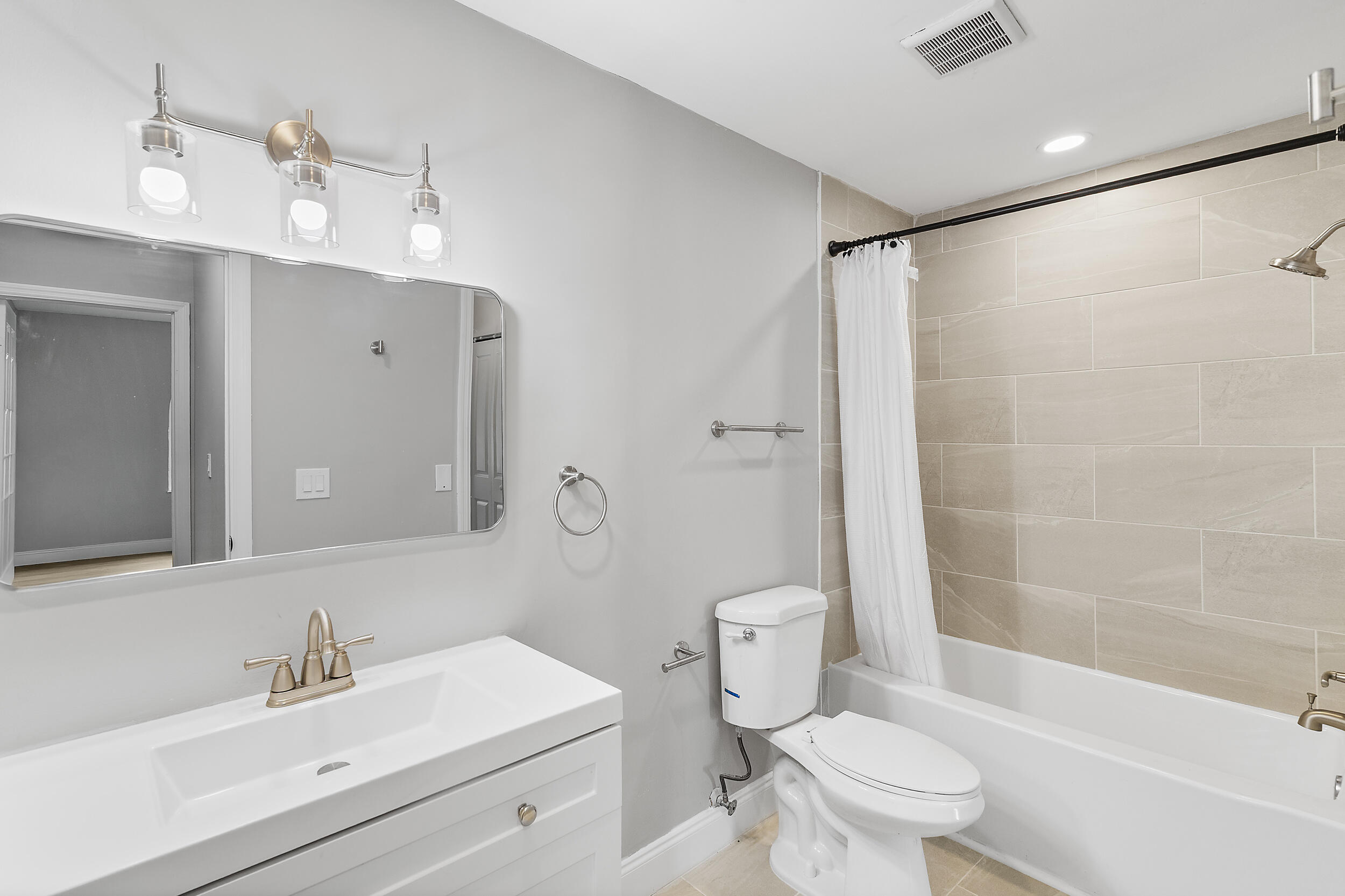 4777 Southeast Salvatori Road Stuart, FL 34997 - Photo 13 of 28 a bathroom with a sink a toilet and shower