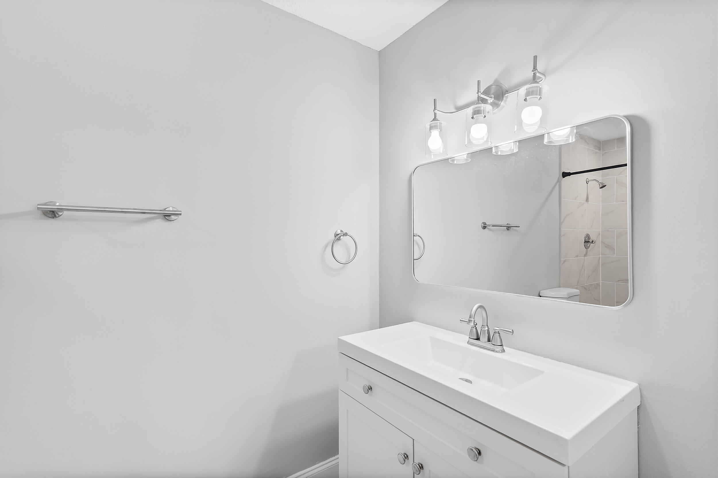 4777 Southeast Salvatori Road Stuart, FL 34997 - Photo 18 of 28 a bathroom with a sink vanity and mirror