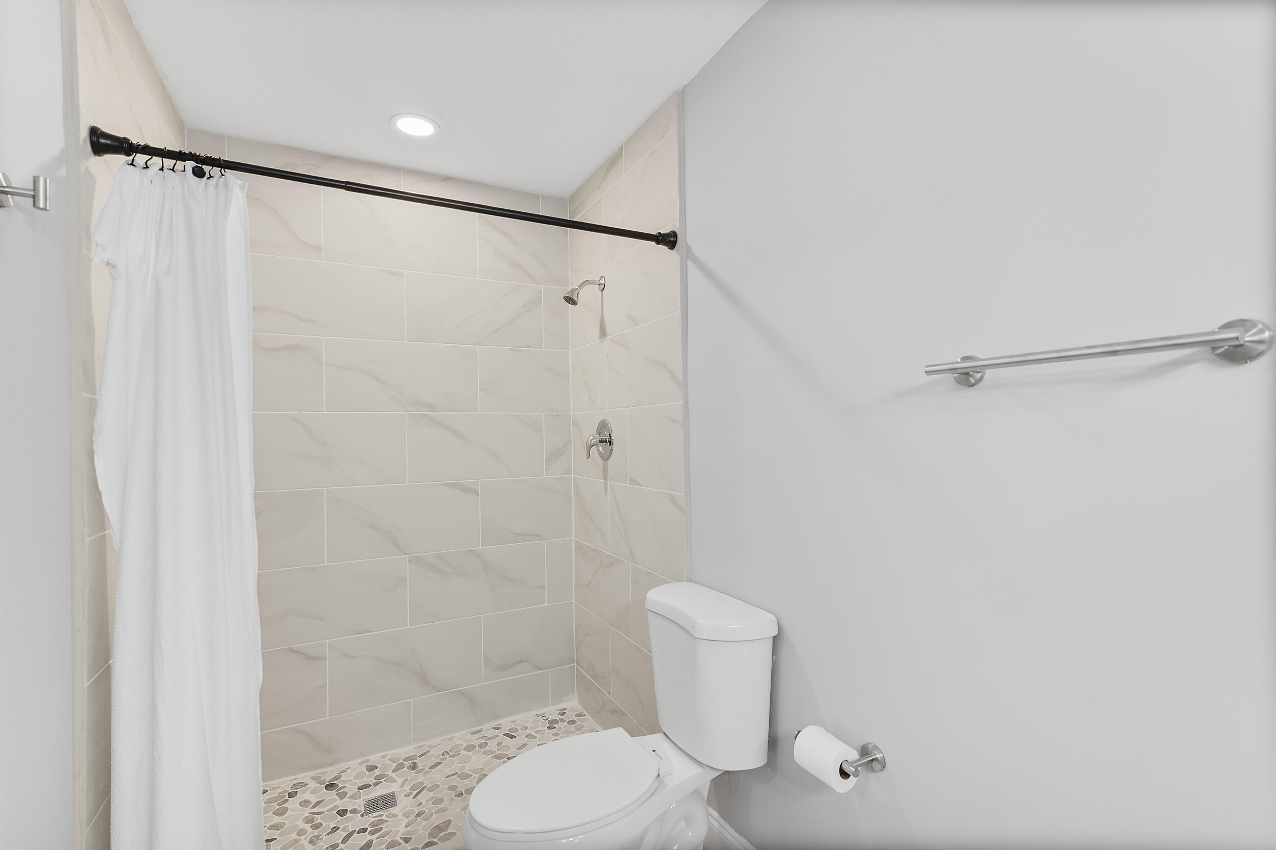 4777 Southeast Salvatori Road Stuart, FL 34997 - Photo 19 of 28 a bathroom with a shower and a toilet