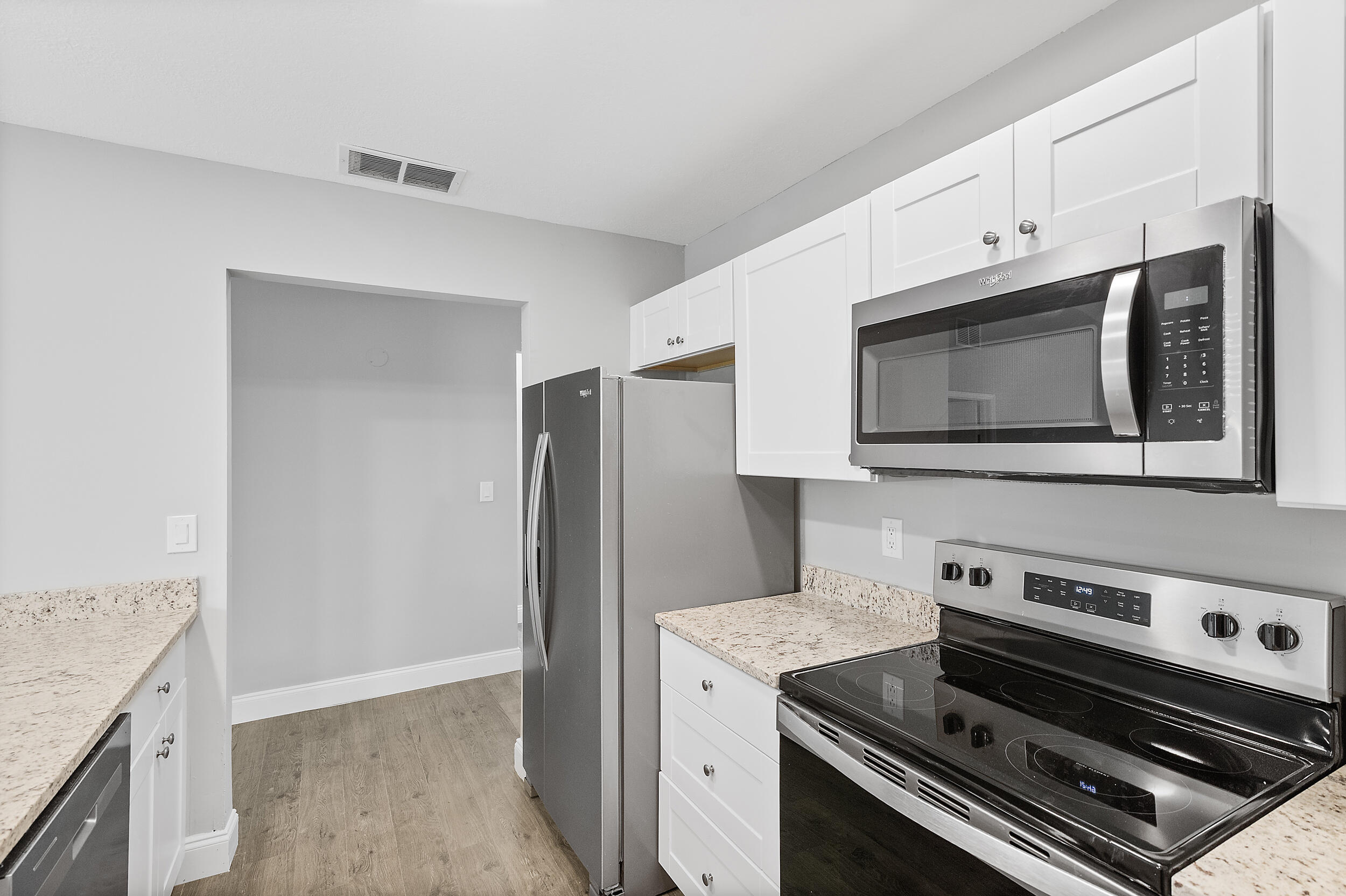 4777 Southeast Salvatori Road Stuart, FL 34997 - Photo 2 of 28 a kitchen with a stove microwave and refrigerator