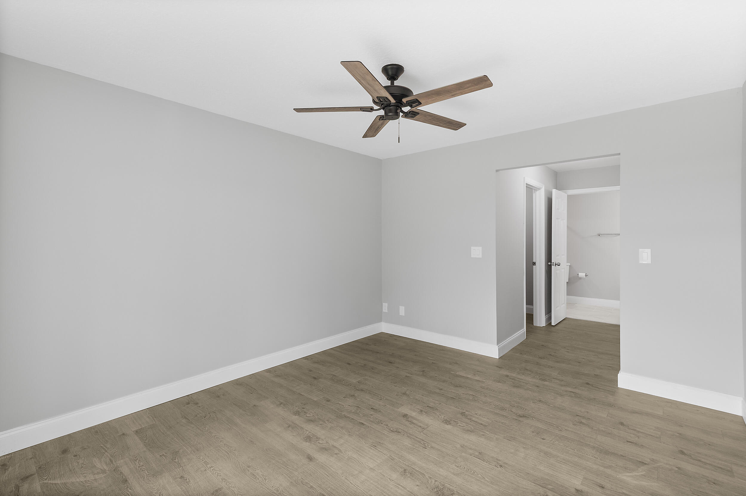 4777 Southeast Salvatori Road Stuart, FL 34997 - Photo 21 of 28 a view of a livingroom with a ceiling fan and wooden floor