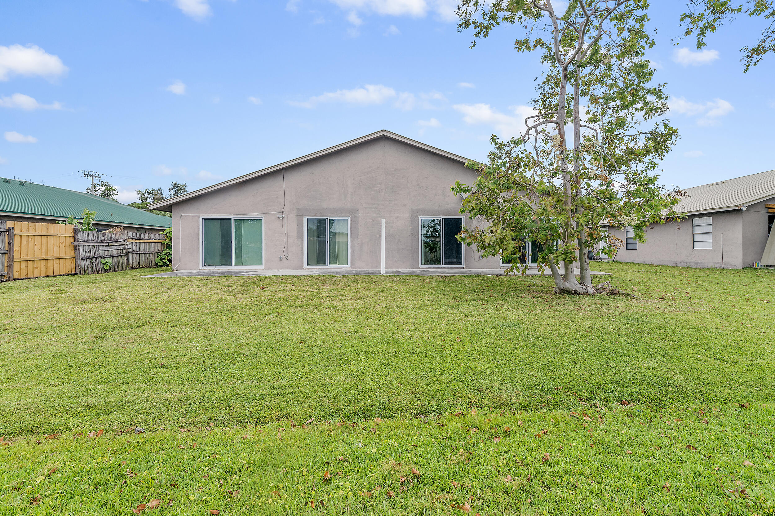 4777 Southeast Salvatori Road Stuart, FL 34997 - Photo 24 of 28 a view of a house with a yard