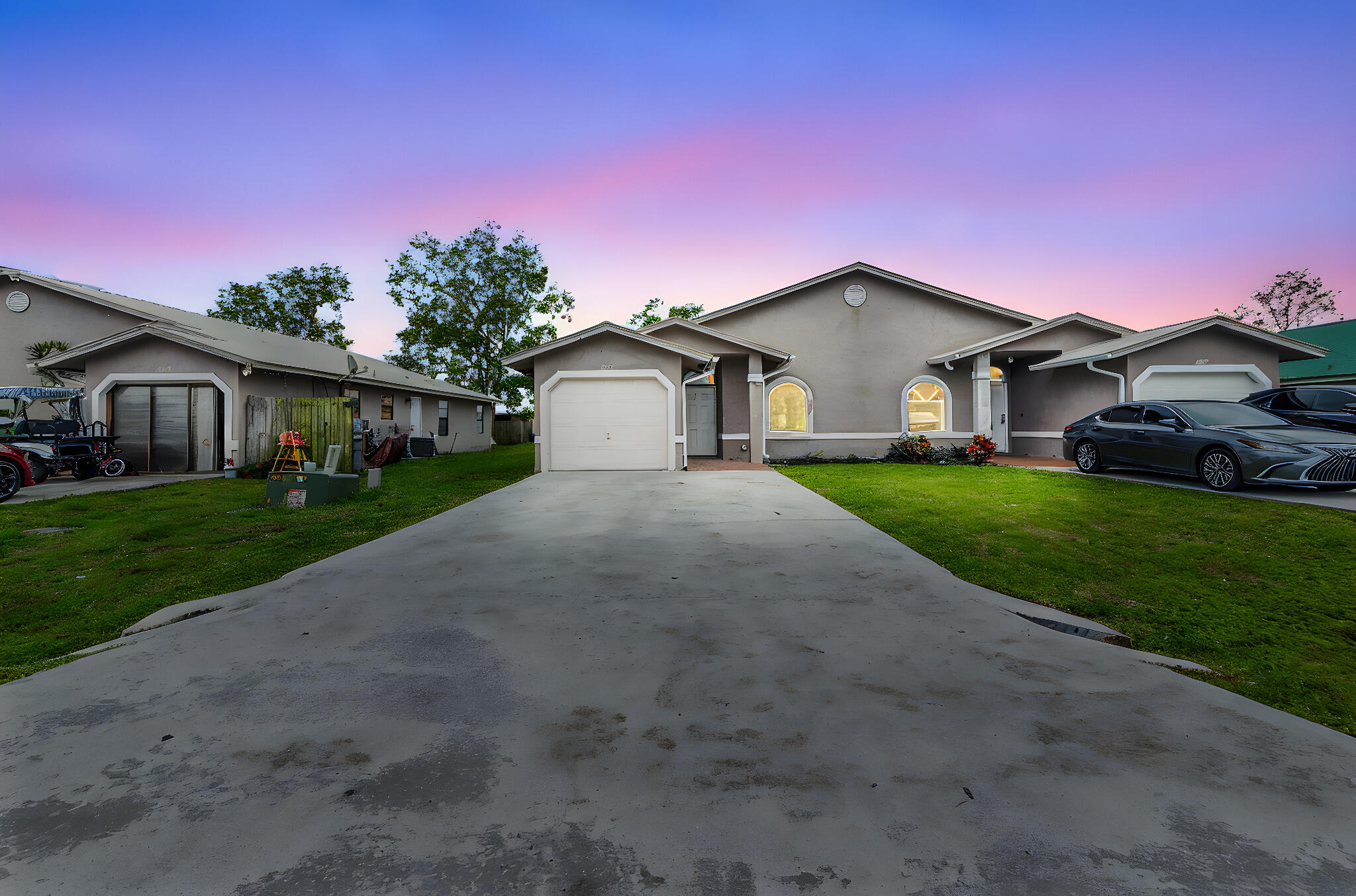 4777 Southeast Salvatori Road Stuart, FL 34997 - Photo 28 of 28 a front view of a house with a yard and garage