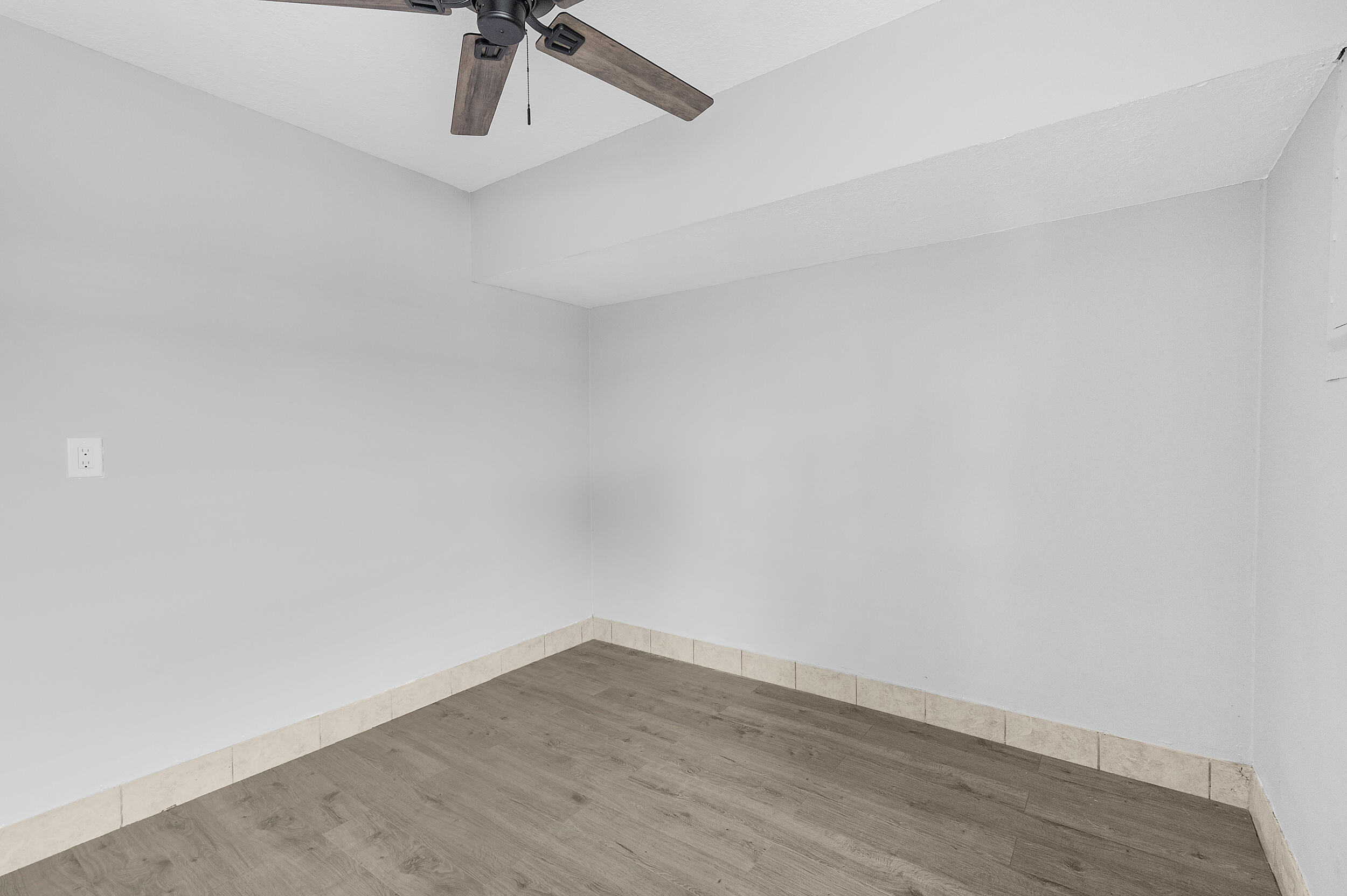 4777 Southeast Salvatori Road Stuart, FL 34997 - Photo 8 of 28 a view of a room with wooden floor and fan