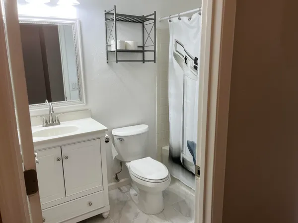 a white toilet sitting next to a bathroom sink