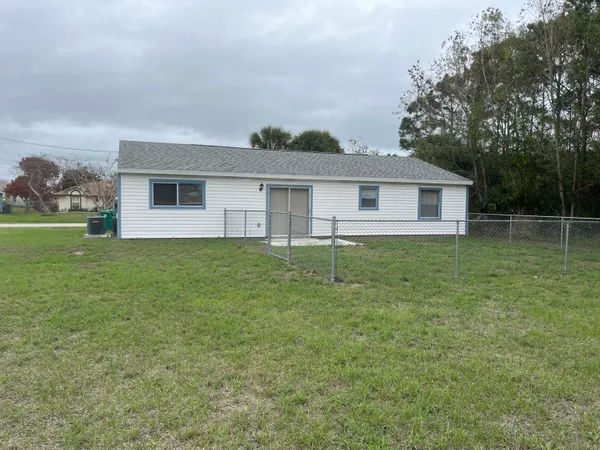 a view of a house with a backyard