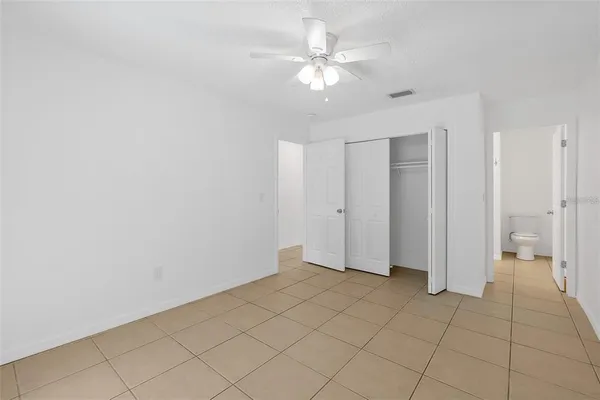 a view of an empty room and closet area