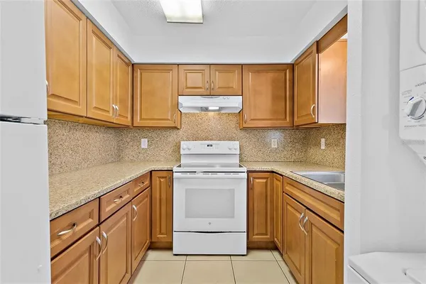 a kitchen with cabinets appliances and a sink