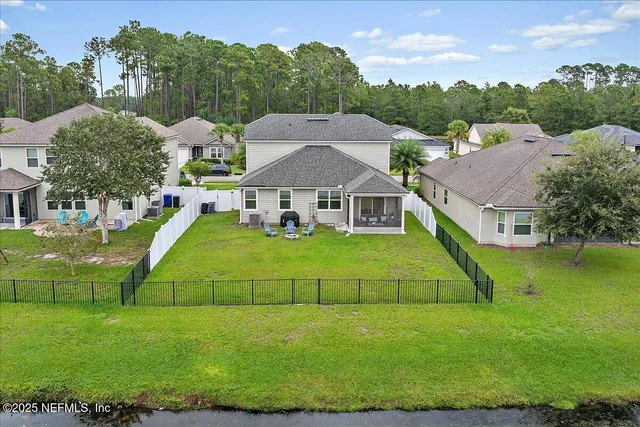 a aerial view of a house with a big yard