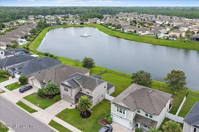 an aerial view of a house with a lake view