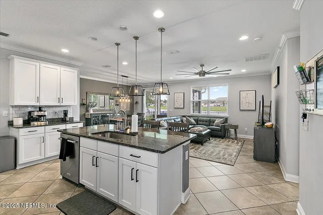 a kitchen with sink cabinets and refrigerator