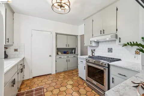 a kitchen with cabinets appliances and a sink