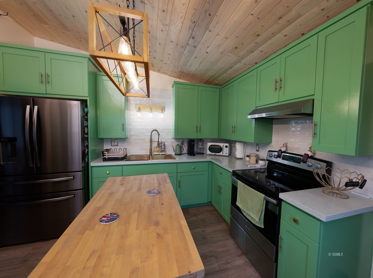 413 North Helena Street Ridgecrest, CA 93555 - Photo 7 of 42 a kitchen with green cabinets a refrigerator and a sink