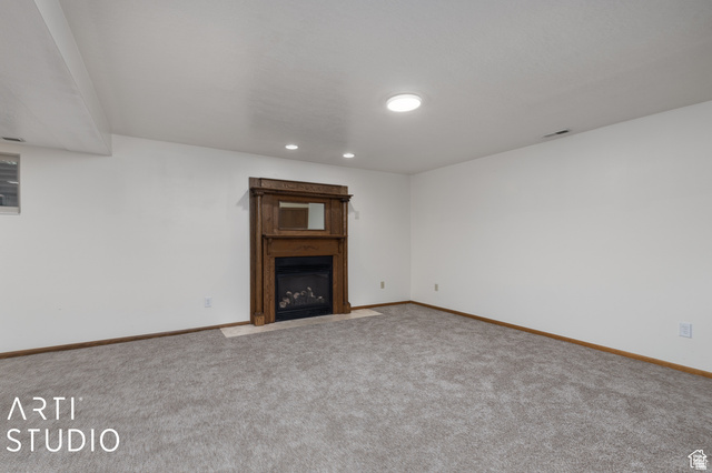 2807 North Ogden Canyon Road Eden, UT 84310 - Photo 38 of 72 Spacious room featuring a wood-finish fireplace surround with a dark metal insert, light-toned hearth, and an integrated mirror