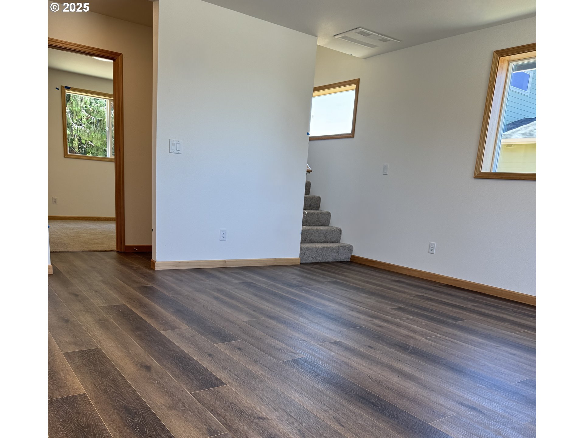 5253 Forest Lane Eugene, OR 97402 - Photo 2 of 25 an empty room with wooden floor and windows