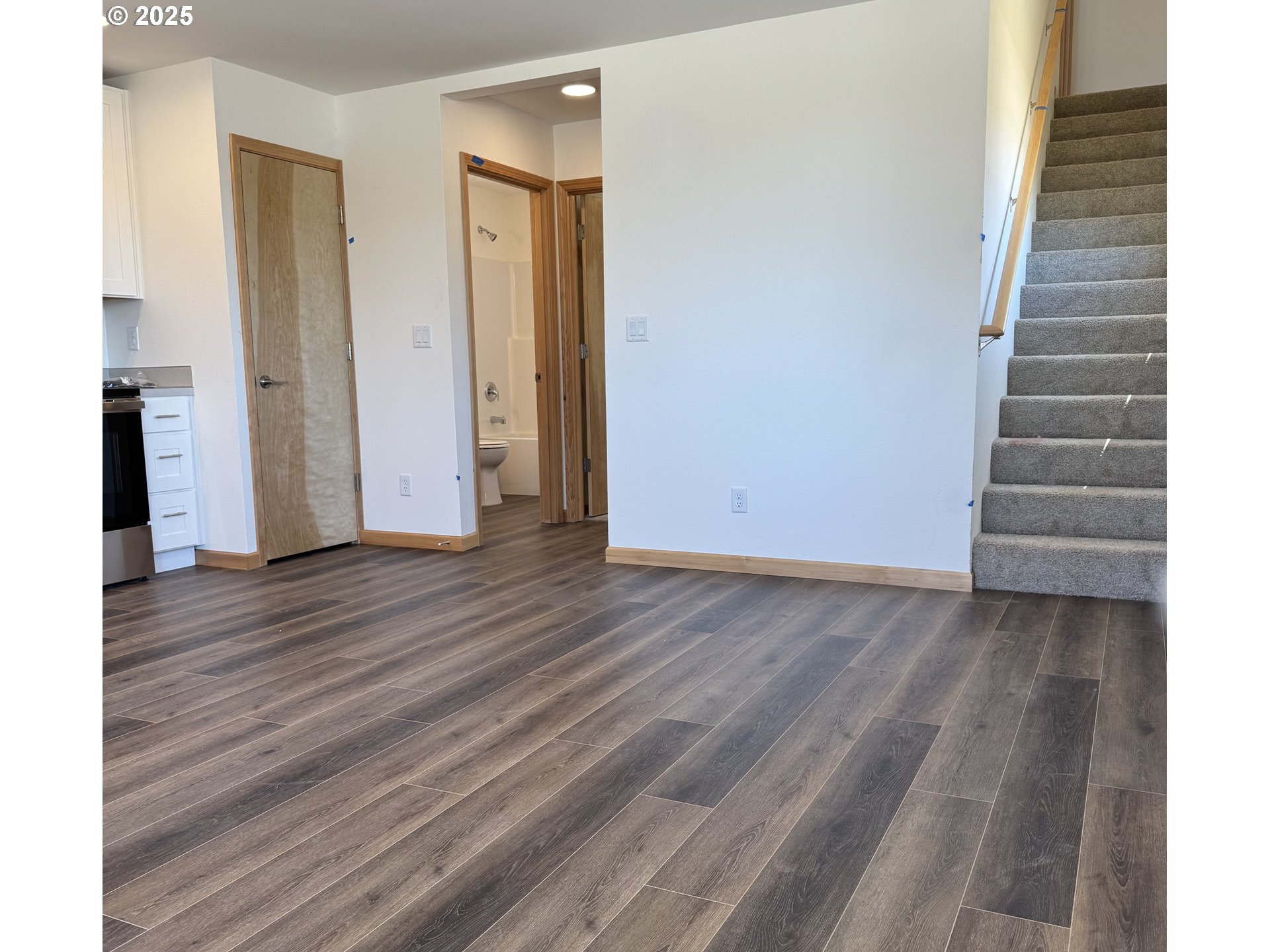 5253 Forest Lane Eugene, OR 97402 - Photo 3 of 25 a view of an empty room with wooden floor and stairs