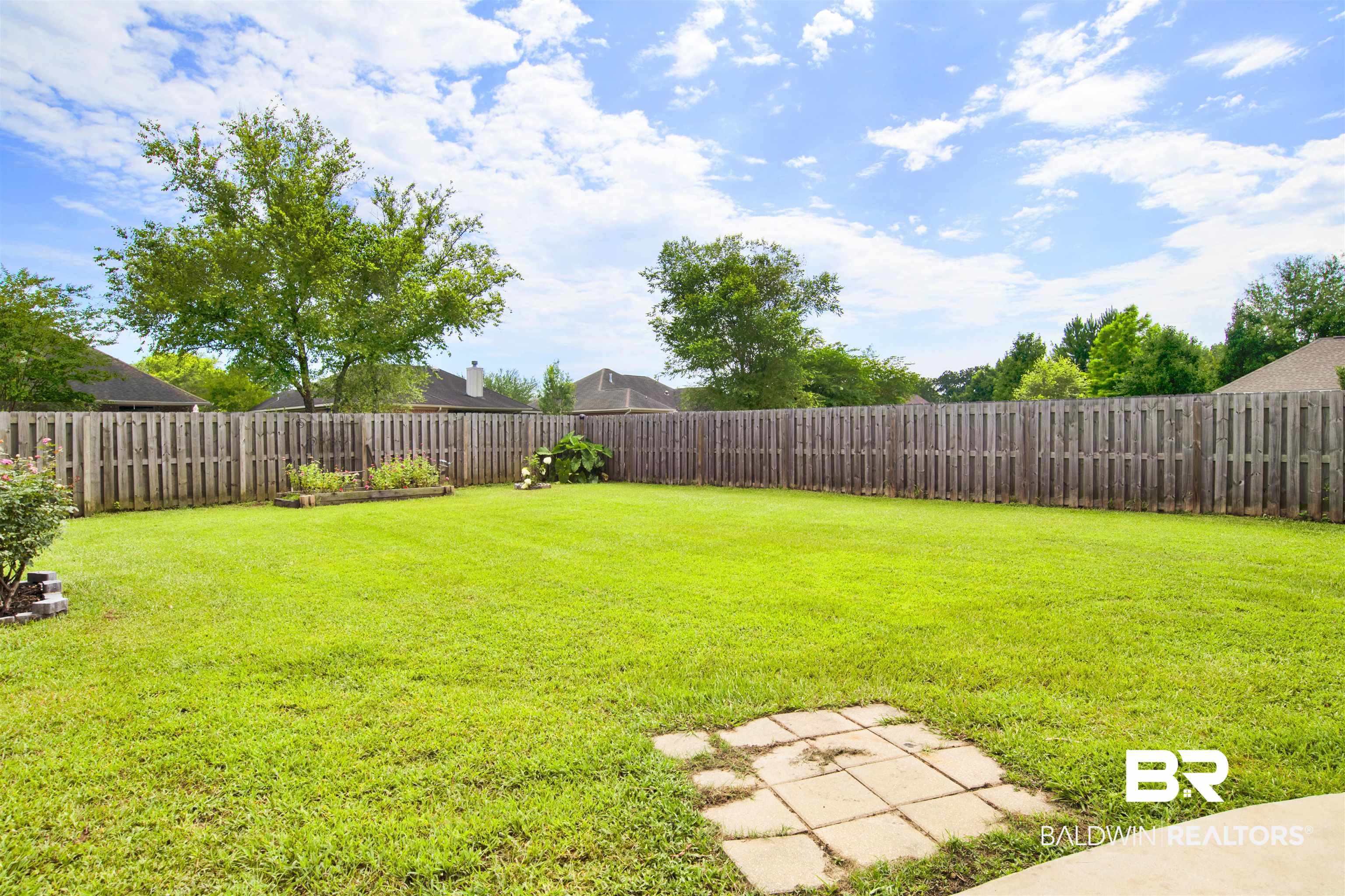 10368 Gayfer Rd Extension Fairhope, AL 36532 - Photo 38 of 43 Expansive green lawn with a full privacy fence