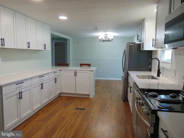 a kitchen with a sink appliances and cabinets