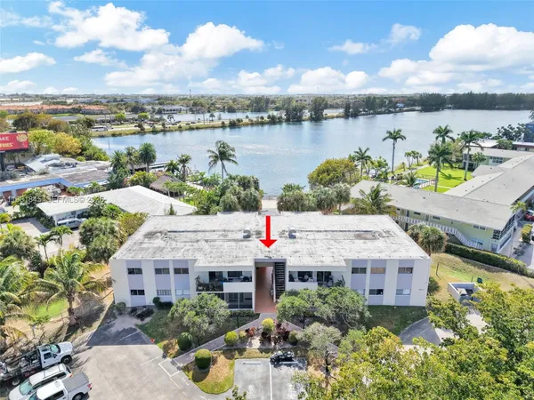 an aerial view of a house with a lake view