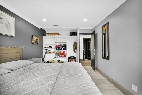 a bedroom with a bed and a large mirror