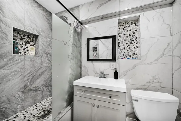 a bathroom with a toilet sink and a mirror