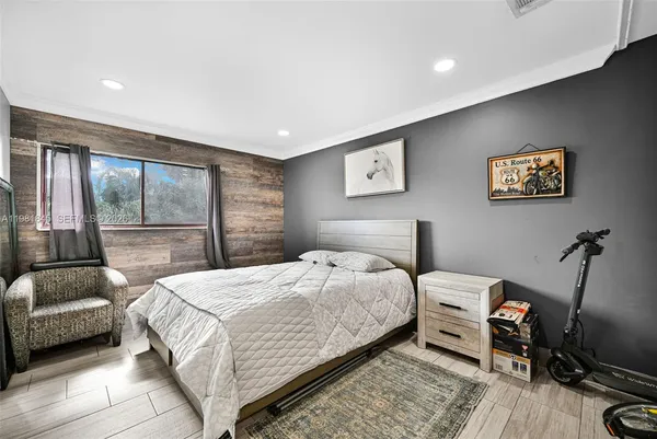 a bedroom with a bed a couch and a window