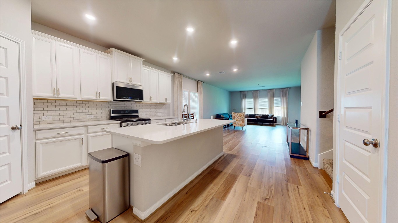 21606 Reserve Ranch Trail Richmond, TX 77407 - Photo 11 of 48 a kitchen with a sink a counter top space stainless steel appliances and cabinets