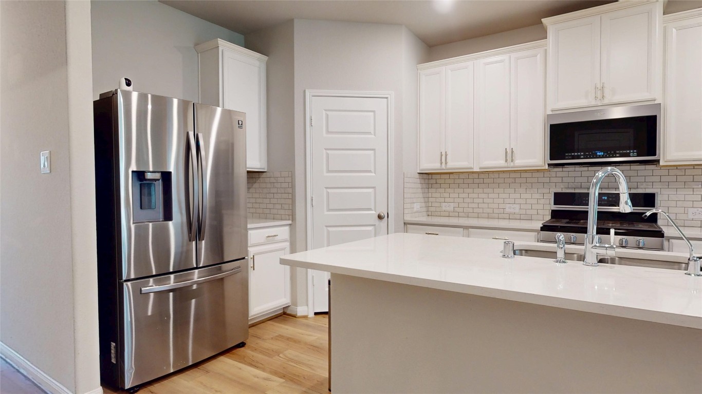 21606 Reserve Ranch Trail Richmond, TX 77407 - Photo 12 of 48 a kitchen with a refrigerator and a sink