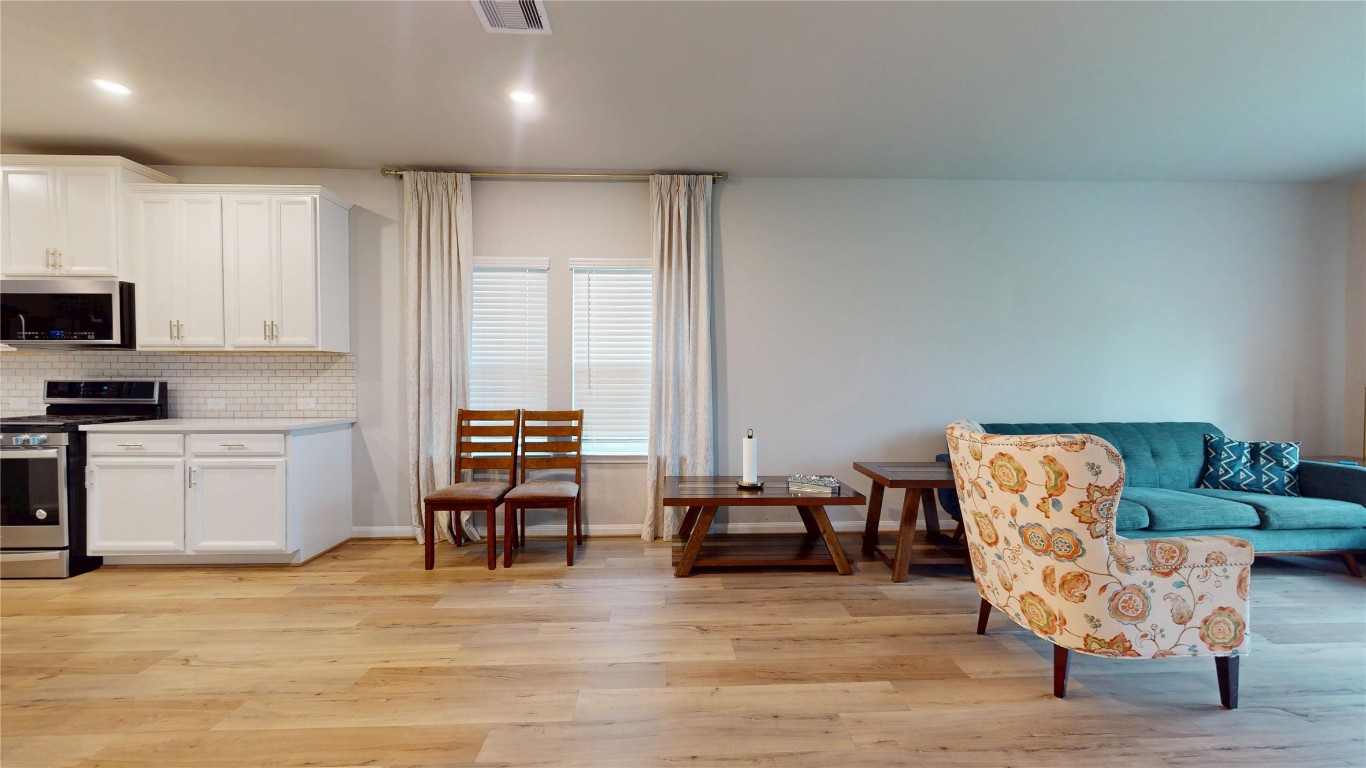 21606 Reserve Ranch Trail Richmond, TX 77407 - Photo 20 of 48 a living room with furniture and a wooden floor