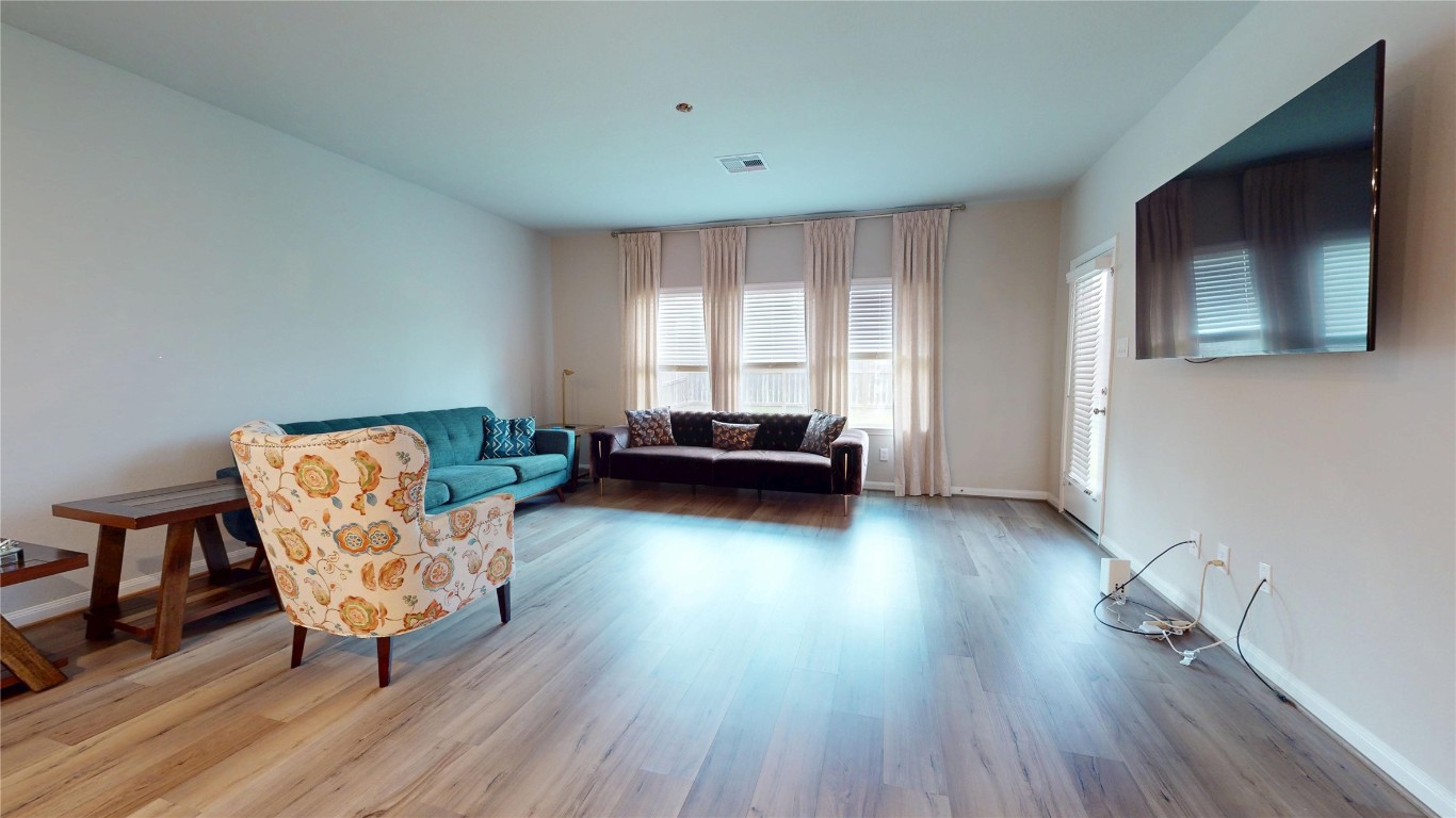 21606 Reserve Ranch Trail Richmond, TX 77407 - Photo 22 of 48 a living room with furniture and a wooden floor