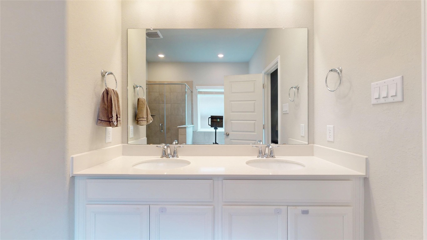 21606 Reserve Ranch Trail Richmond, TX 77407 - Photo 30 of 48 a bathroom with a sink and a mirror