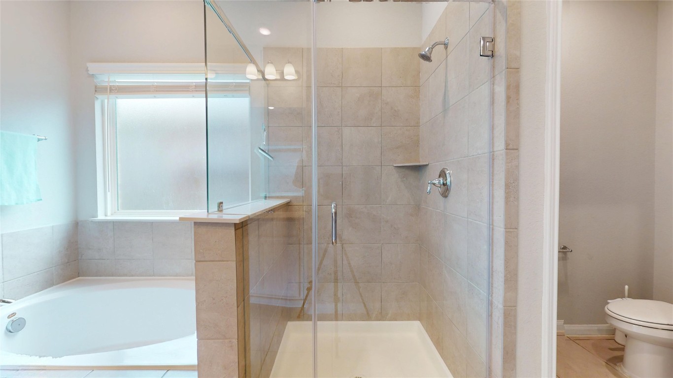 21606 Reserve Ranch Trail Richmond, TX 77407 - Photo 31 of 48 a bathroom with a shower and a toilet