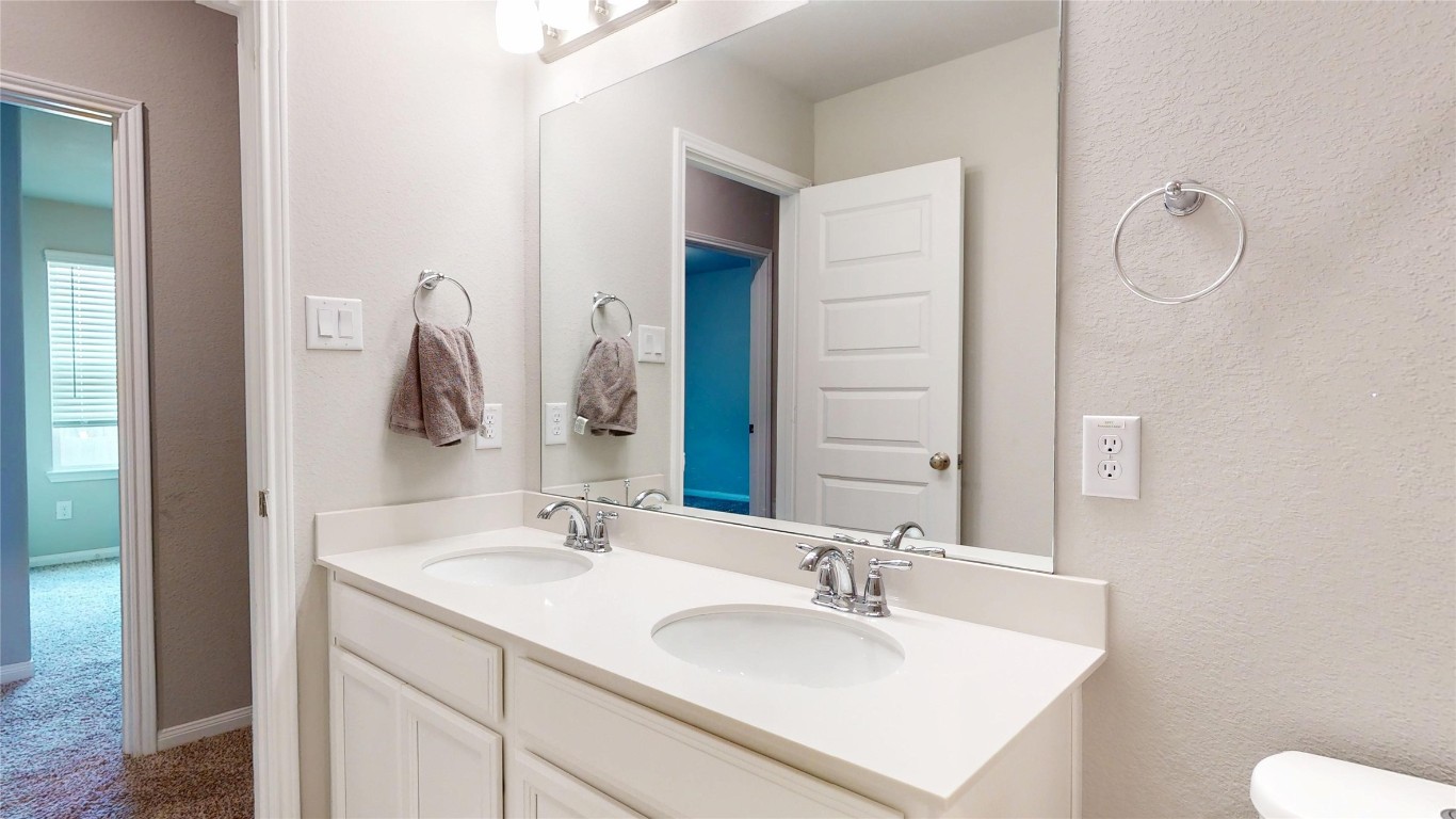 21606 Reserve Ranch Trail Richmond, TX 77407 - Photo 44 of 48 a bathroom with a sink vanity granite and a mirror