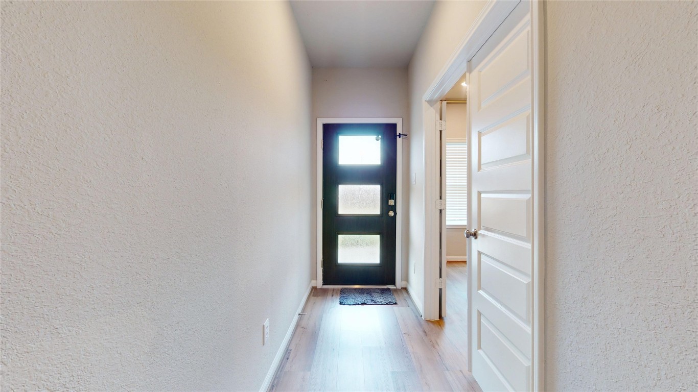 21606 Reserve Ranch Trail Richmond, TX 77407 - Photo 5 of 48 a view of hallway with stairs and wooden floor
