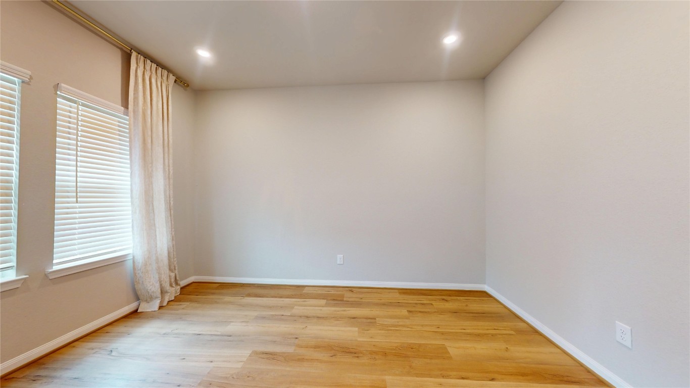 21606 Reserve Ranch Trail Richmond, TX 77407 - Photo 7 of 48 a view of an empty room with wooden floor and a window