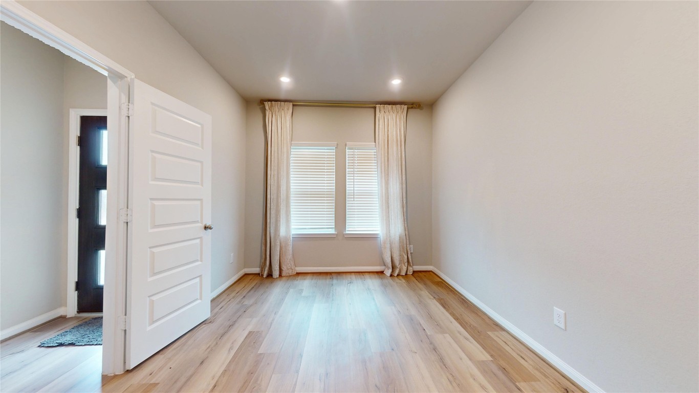 21606 Reserve Ranch Trail Richmond, TX 77407 - Photo 8 of 48 wooden floor in an empty room with a window