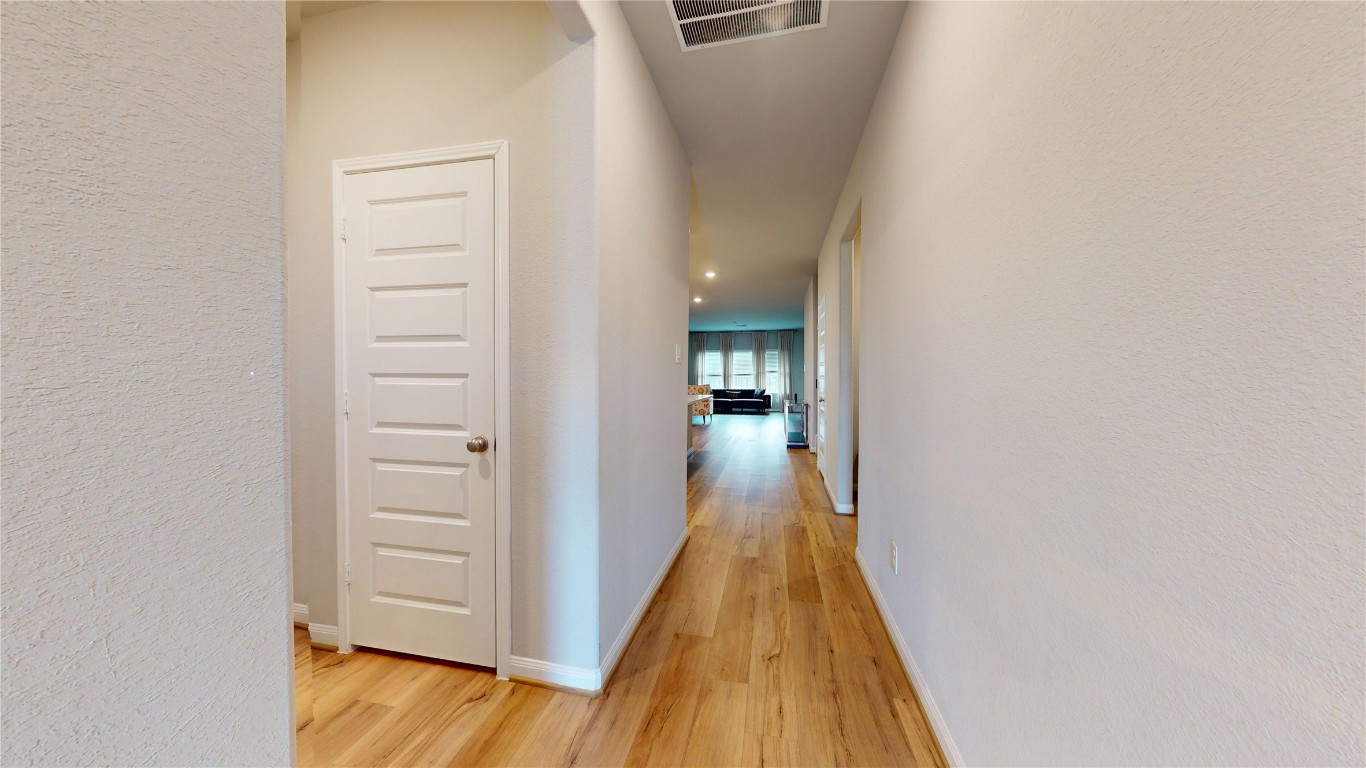 21606 Reserve Ranch Trail Richmond, TX 77407 - Photo 10 of 48 a view of a hallway with a wooden floor