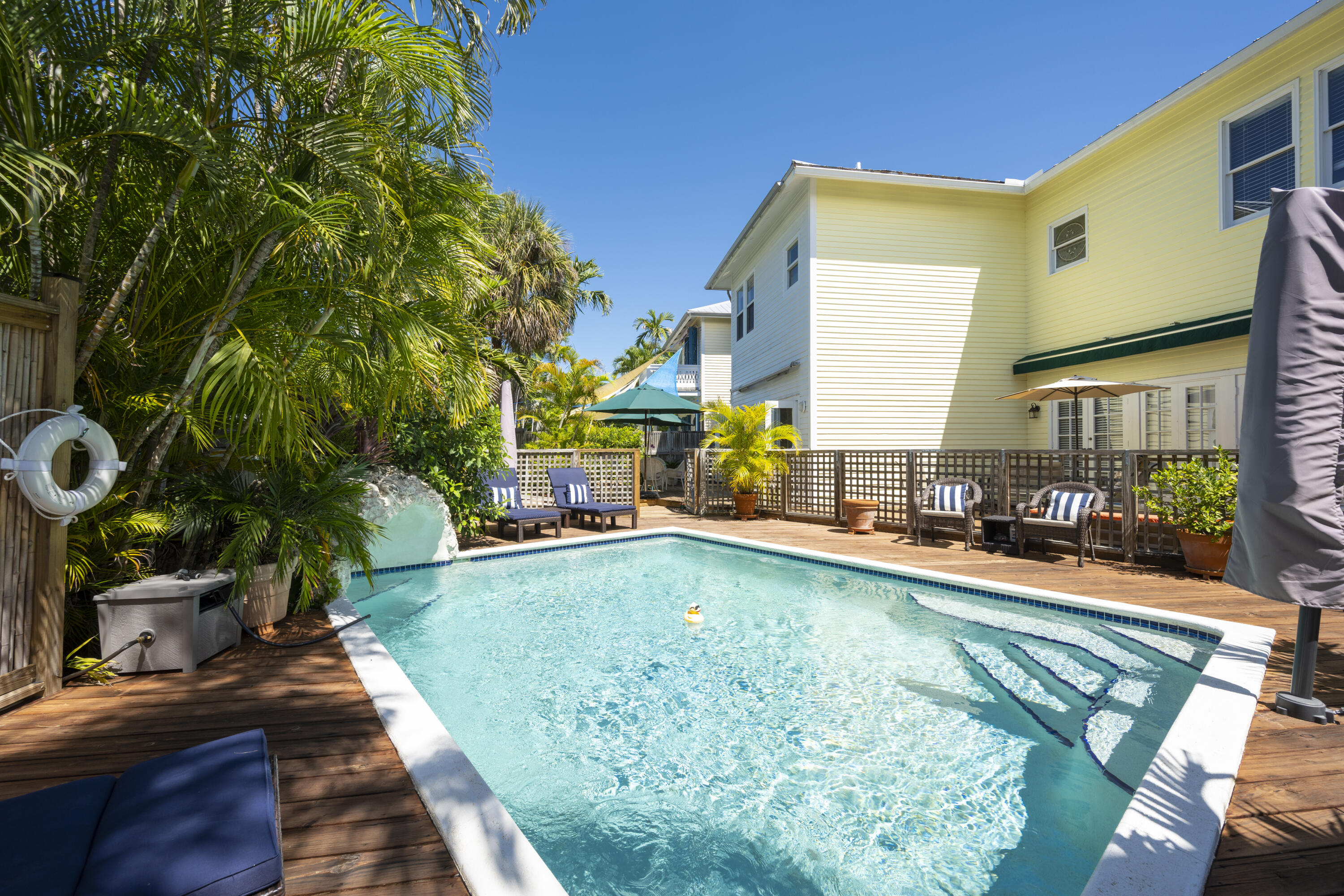 1003 United Street, Unit B Key West, FL 33040 - Photo 1 of 39 a swimming pool with outdoor seating and yard