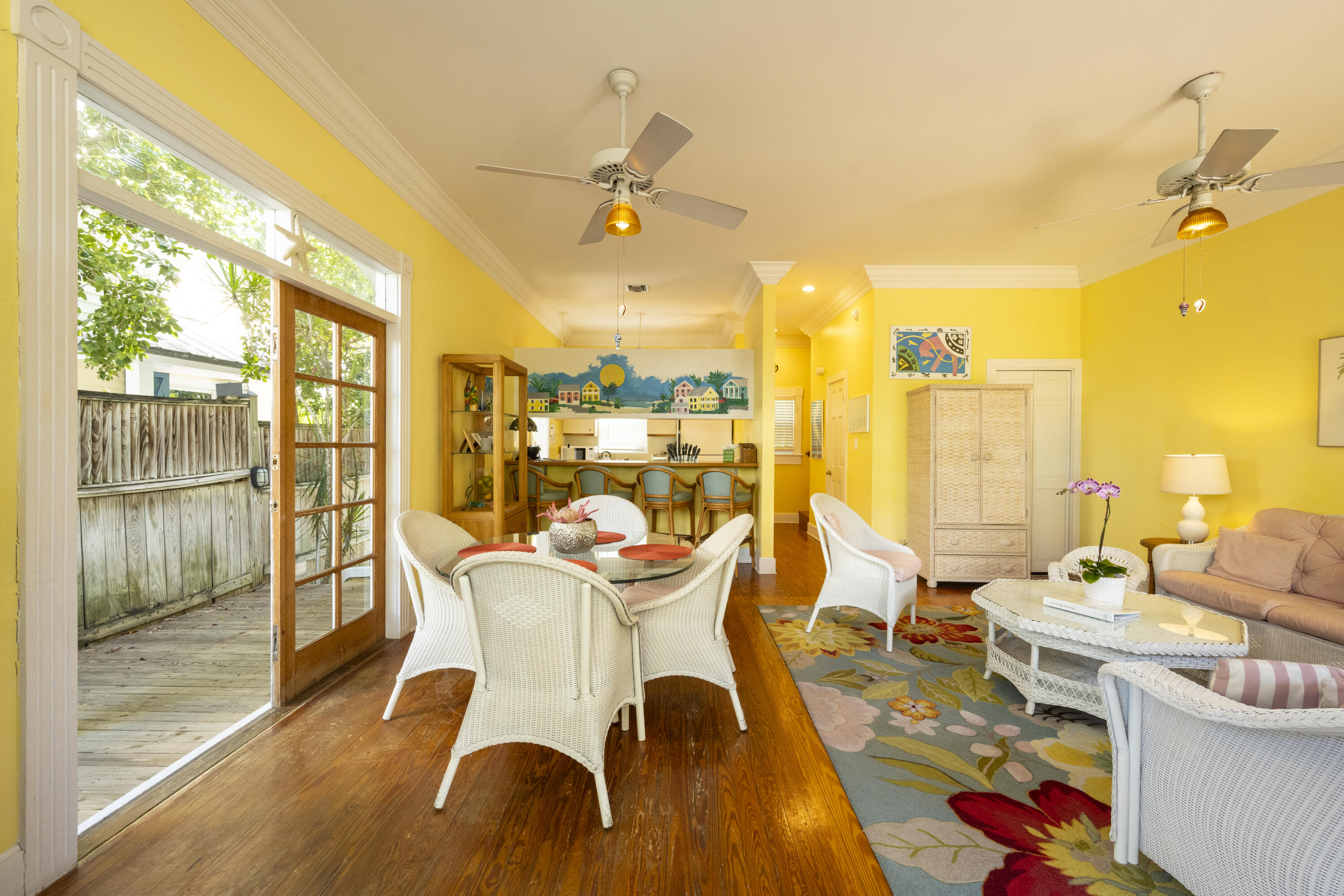 1003 United Street, Unit B Key West, FL 33040 - Photo 12 of 39 a dining room with furniture a chandelier and wooden floor