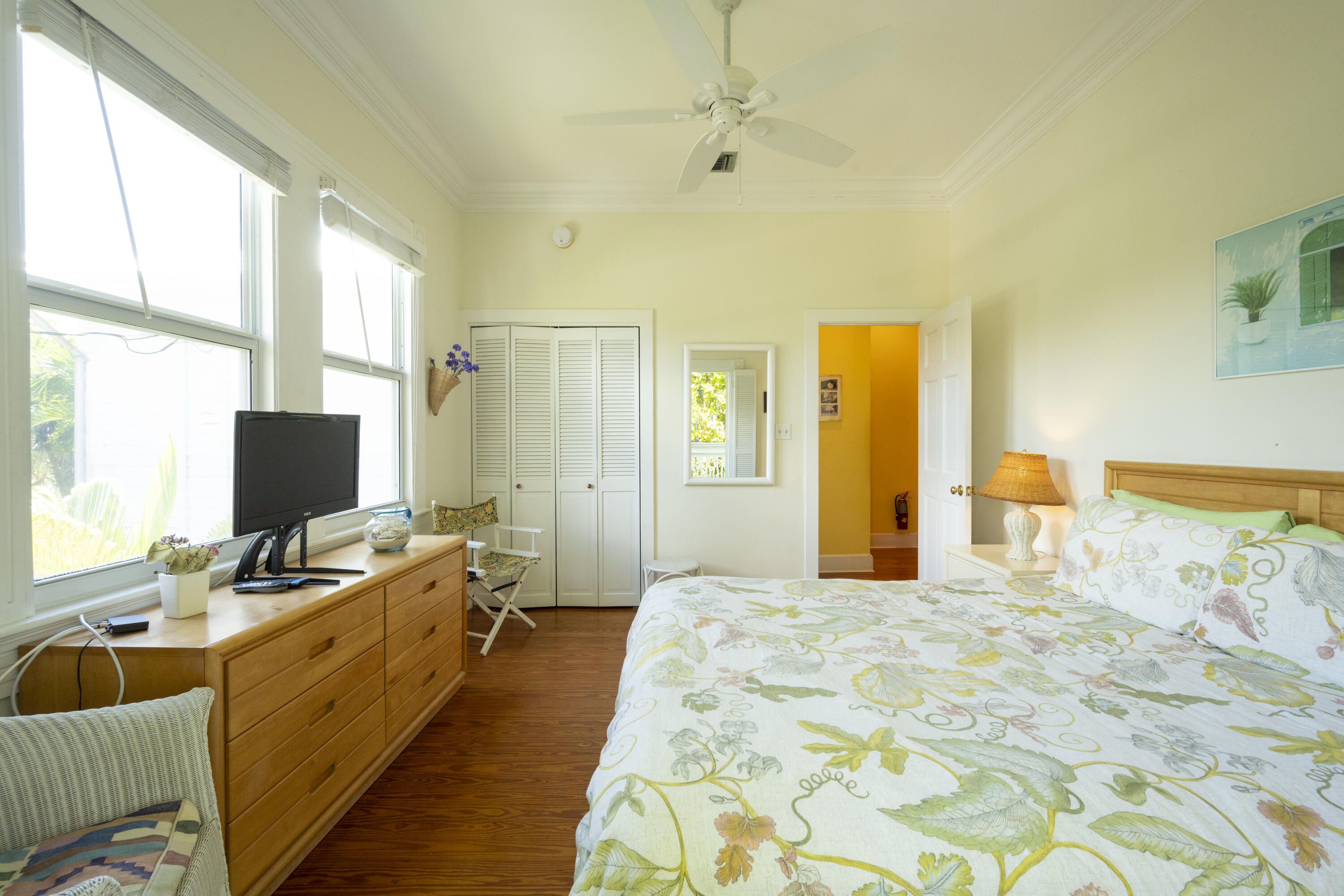 1003 United Street, Unit B Key West, FL 33040 - Photo 25 of 39 a large bedroom with a bed and wooden floor