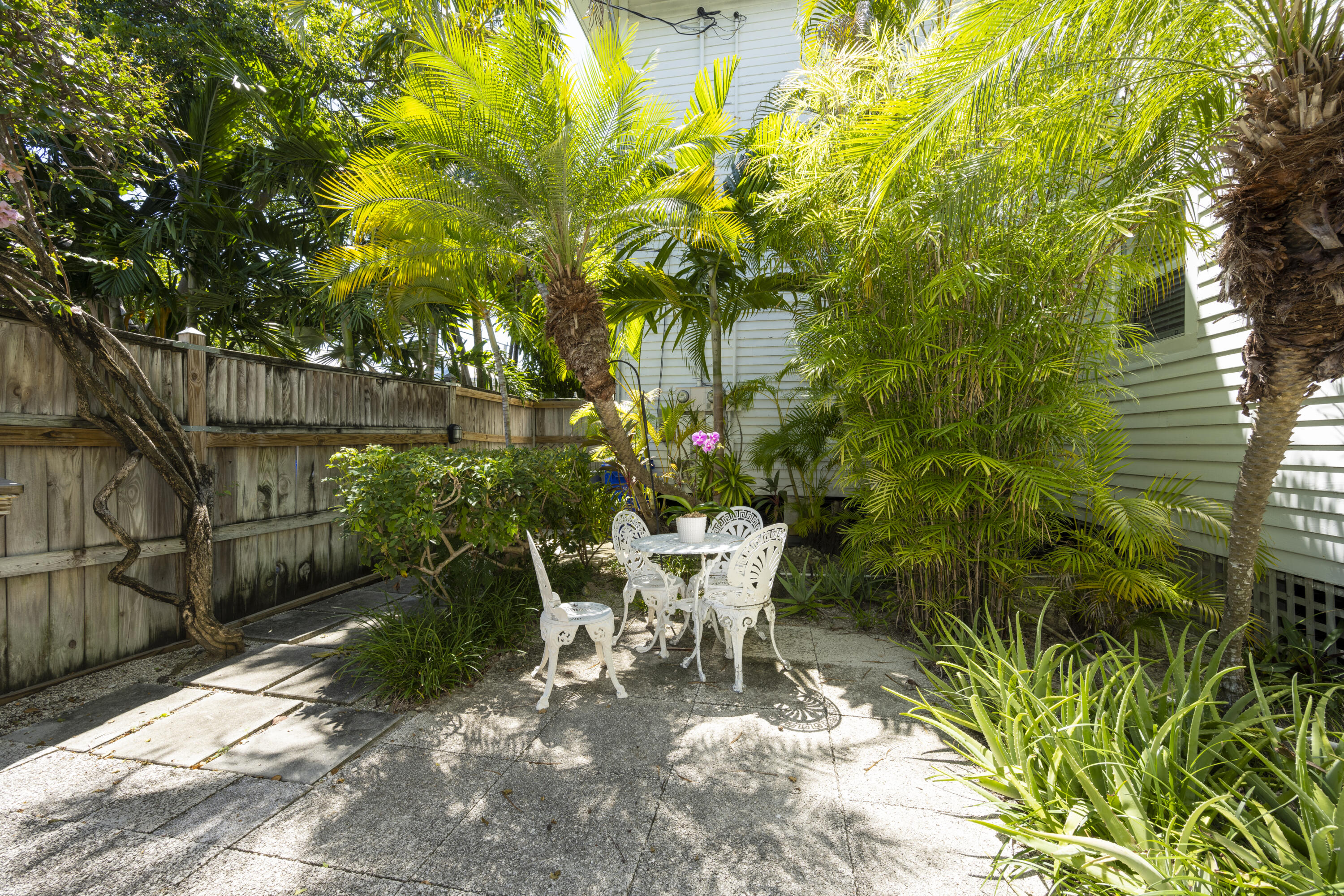 1003 United Street, Unit B Key West, FL 33040 - Photo 4 of 39 a view of a chair and table in backyard