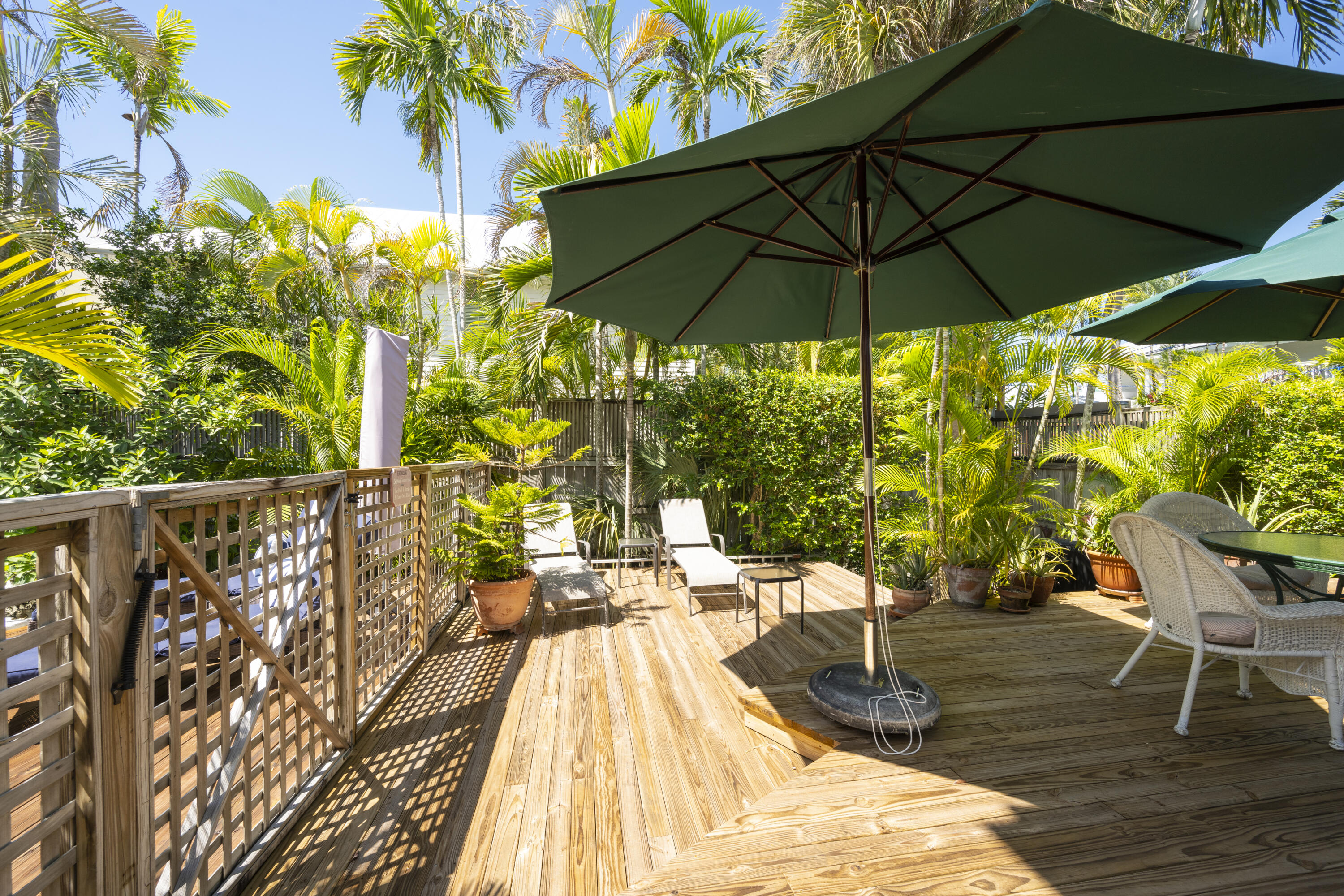 1003 United Street, Unit B Key West, FL 33040 - Photo 36 of 39 a view of balcony with chairs and umbrella