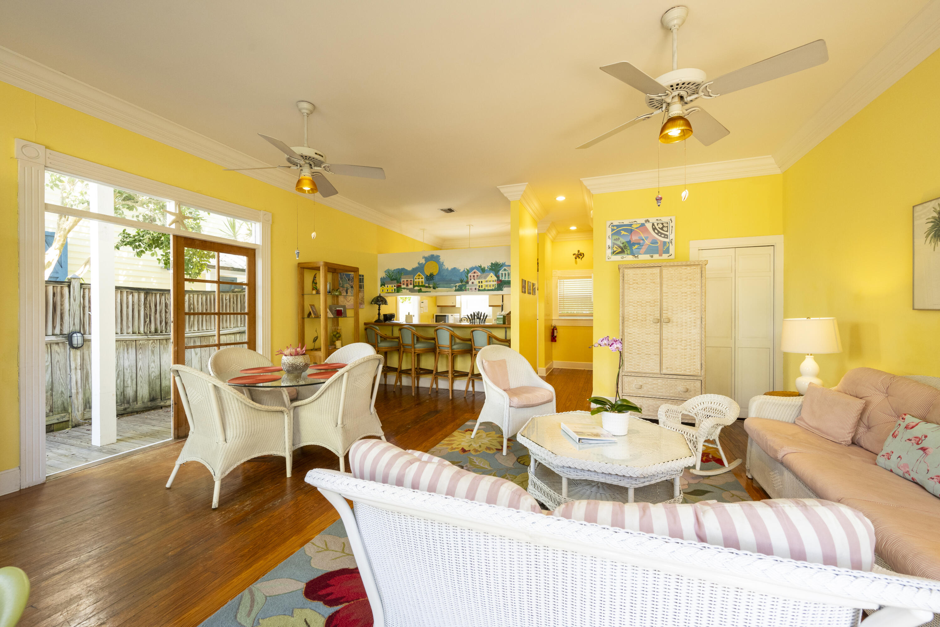 1003 United Street, Unit B Key West, FL 33040 - Photo 7 of 39 a dining room with furniture a chandelier and wooden floor