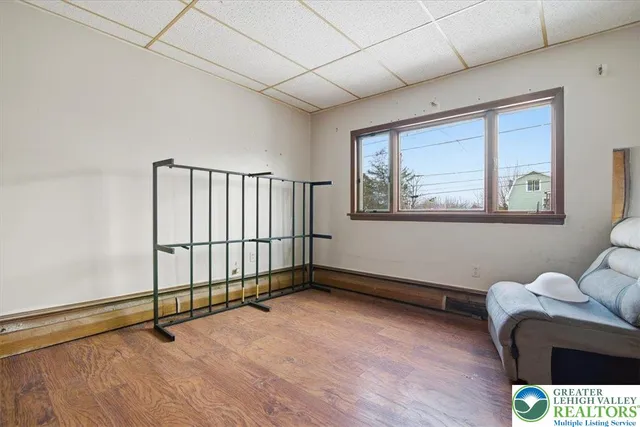 a room with pool table and windows