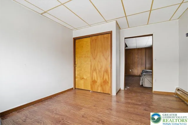 a room with table chairs and wooden floor