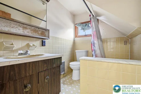 a view of kitchen with refrigerator and window